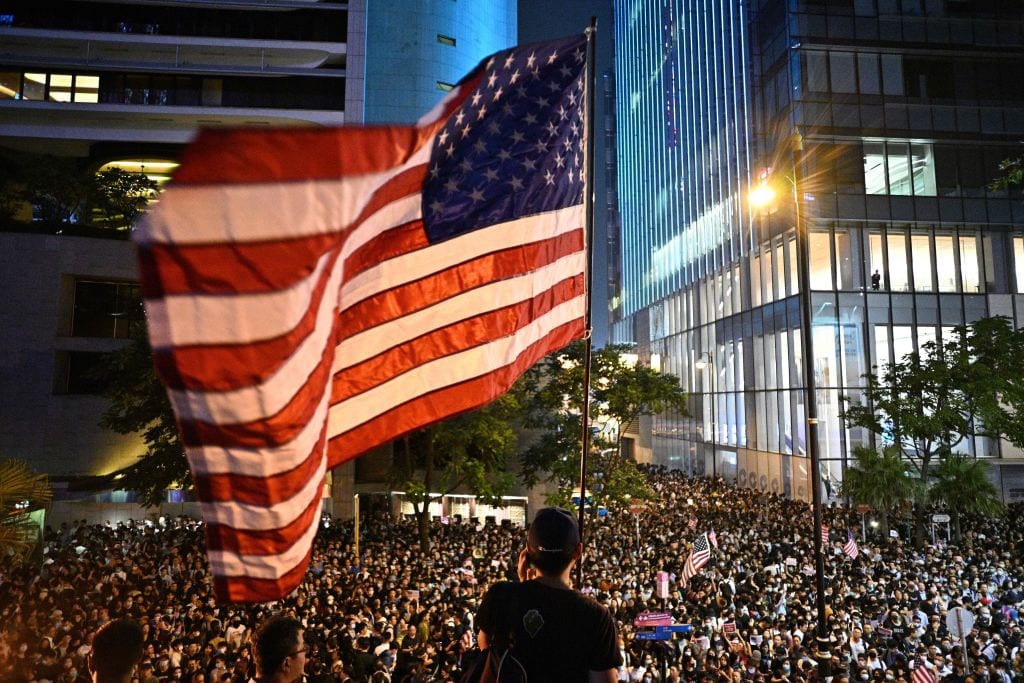 A man waves a US national flag as protesters attend a rally in Hong Kong on October 14, 2019.
