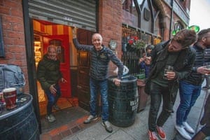 Bittles bar owner John Bittles closes his pub in Belfast on 16 October, 2020, as Northern Ireland imposes tighter coronavirus restrictions on the hospitality sector amid an uptick in Covid-19 cases.