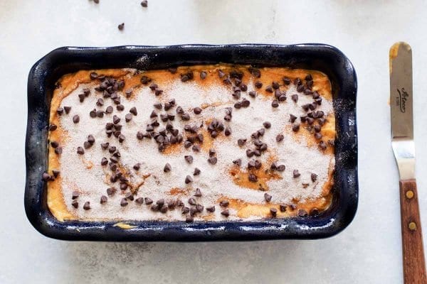 Sugar topped chocolate chip bread batter in a loaf pan.