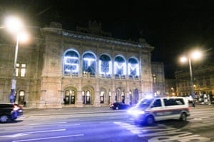 A police car patrols in front of the Vienna Opera House with the inscription reading: ‘ Mute’, following gunfire in the city center of Vienna.