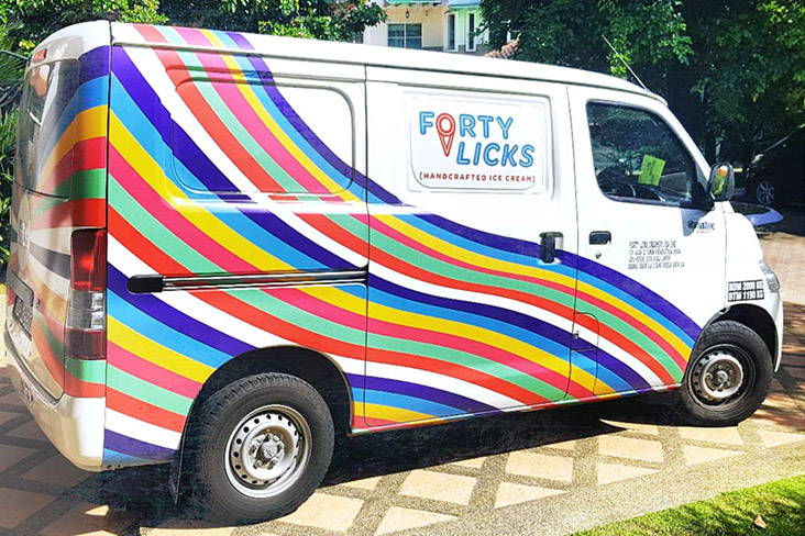 The iconic rainbow-striped van bringing Forty Licks Ice Cream to various neighbourhoods