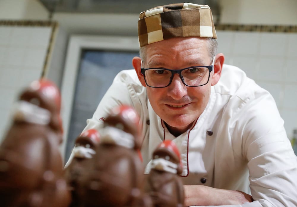 Hungarian confectioner Laszlo Rimoczi poses with chocolate Santas wearing protective face masks at his workshop, during the coronavirus disease outbreak in Lajosmizse, Hungary, November 20, 2020. Picture taken November 20, 2020. — Reuters pic