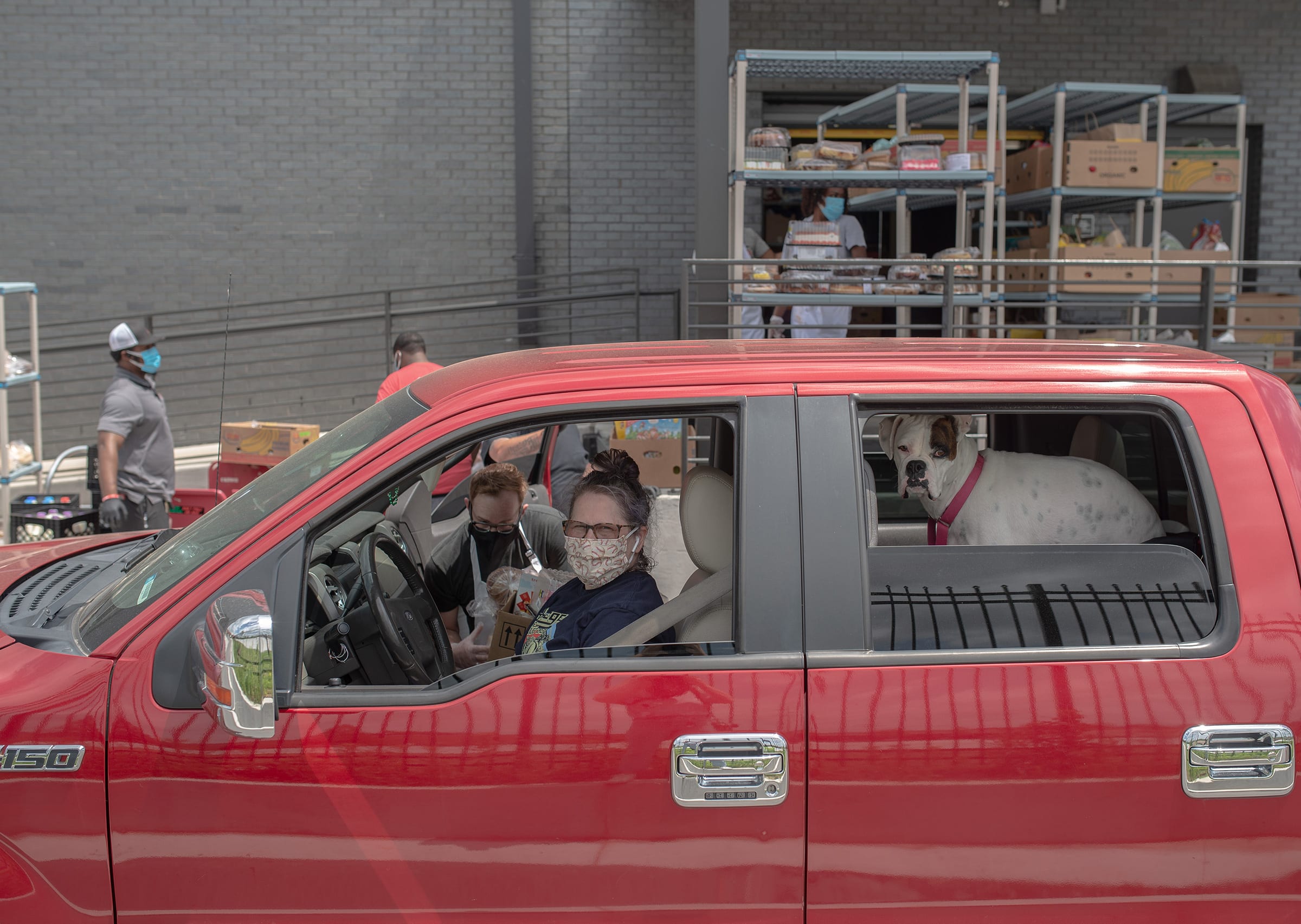 Stacy Aaensom, of Tulsa, Okla., on May 4. She picked up groceries at the Iron Gate drive-through food pantry for some relatives. “They haven’t asked me to do that but they don’t have a car,” she says,  so I’ve been doing that to help them out.