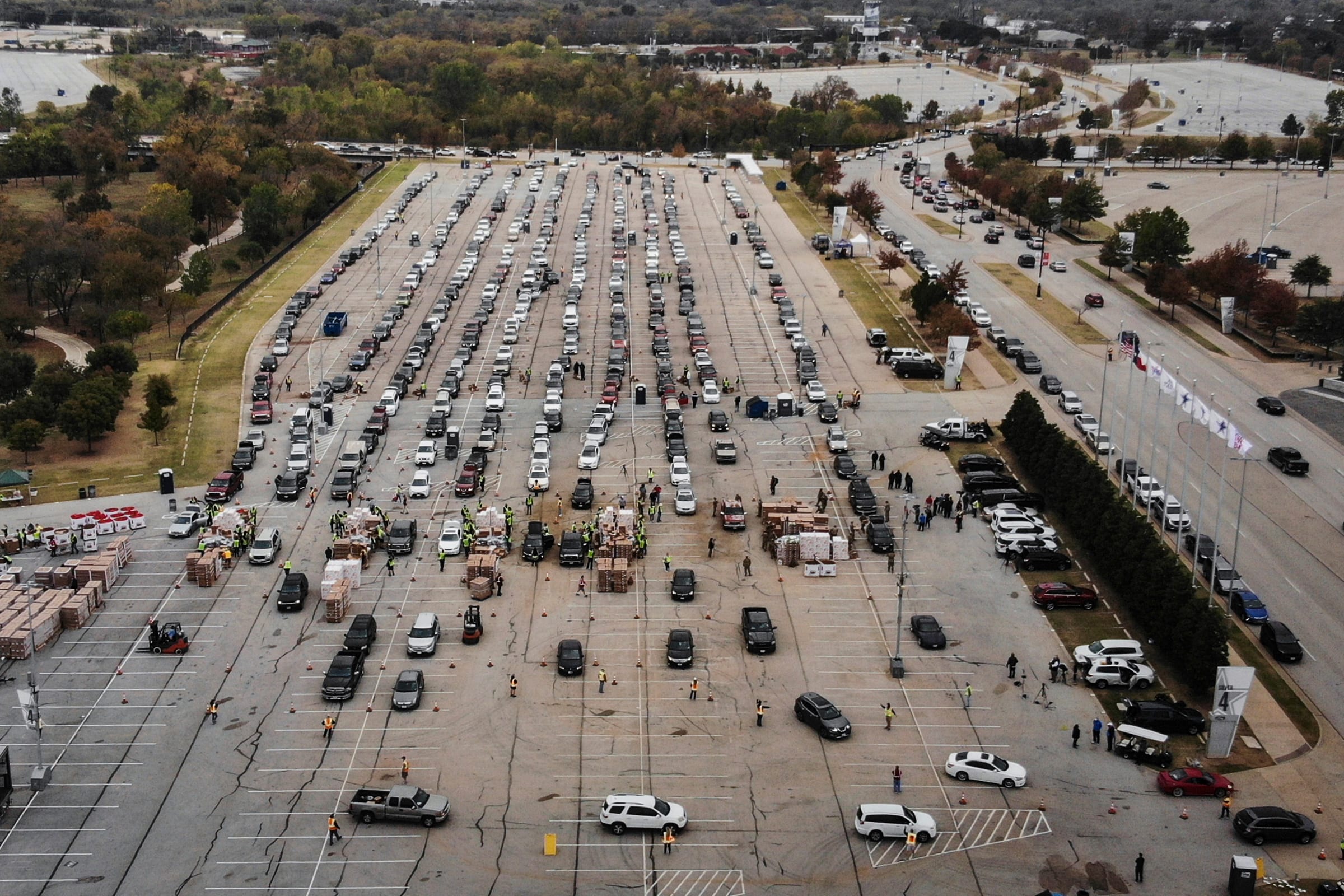 People line up in their cars to receive Thanksgiving meal boxes, which include a turkey and pantry items, from the Tarrant Area Food Bank in Arlington, Texas, on Nov. 20.