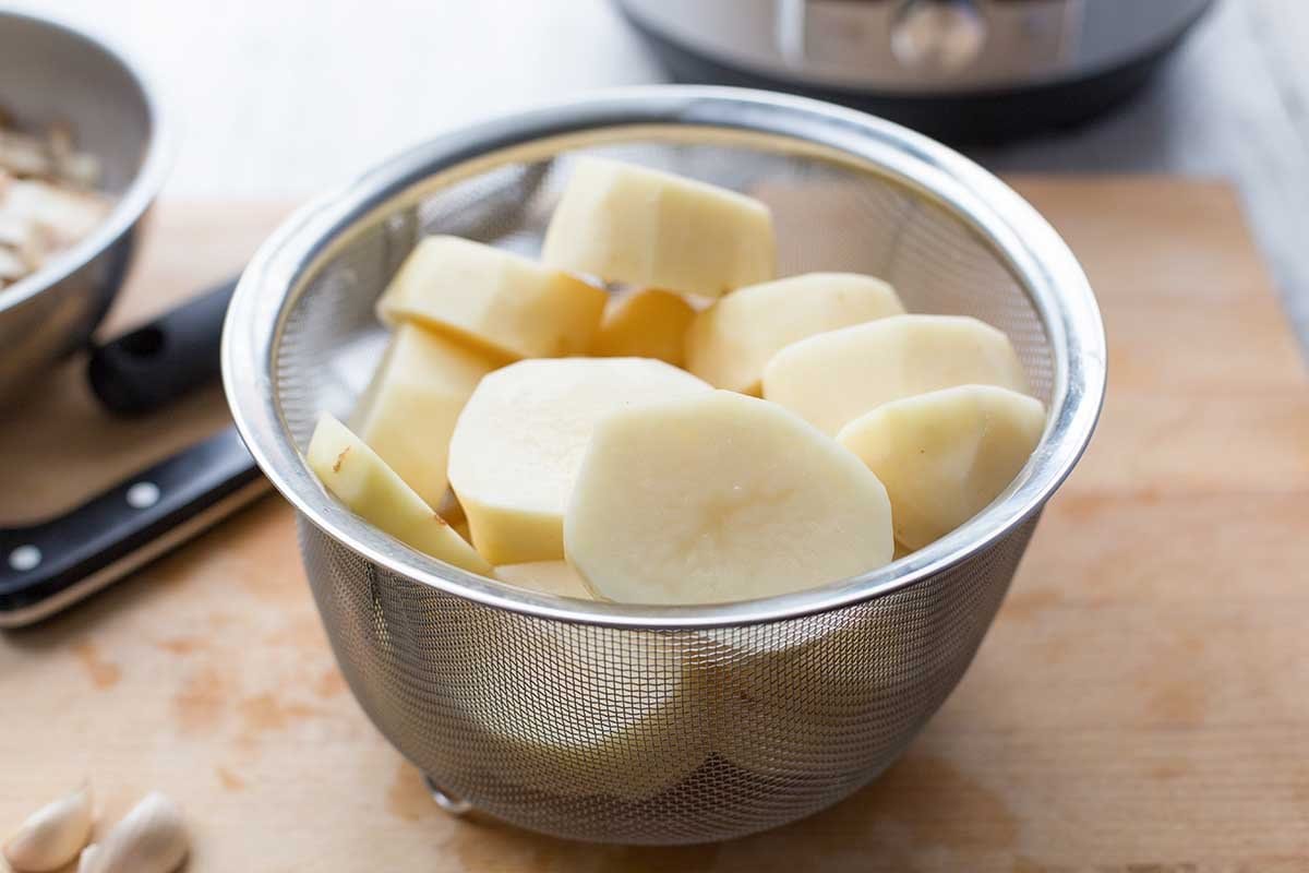 Pressure Cooker Mashed Potatoes sliced in a strainer
