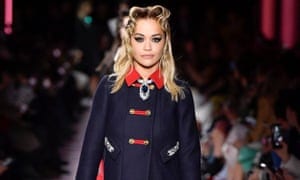 Rita Ora walks the runway at the Miu Miu fashion show earlier this year.