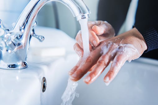 Woman washing hands at home