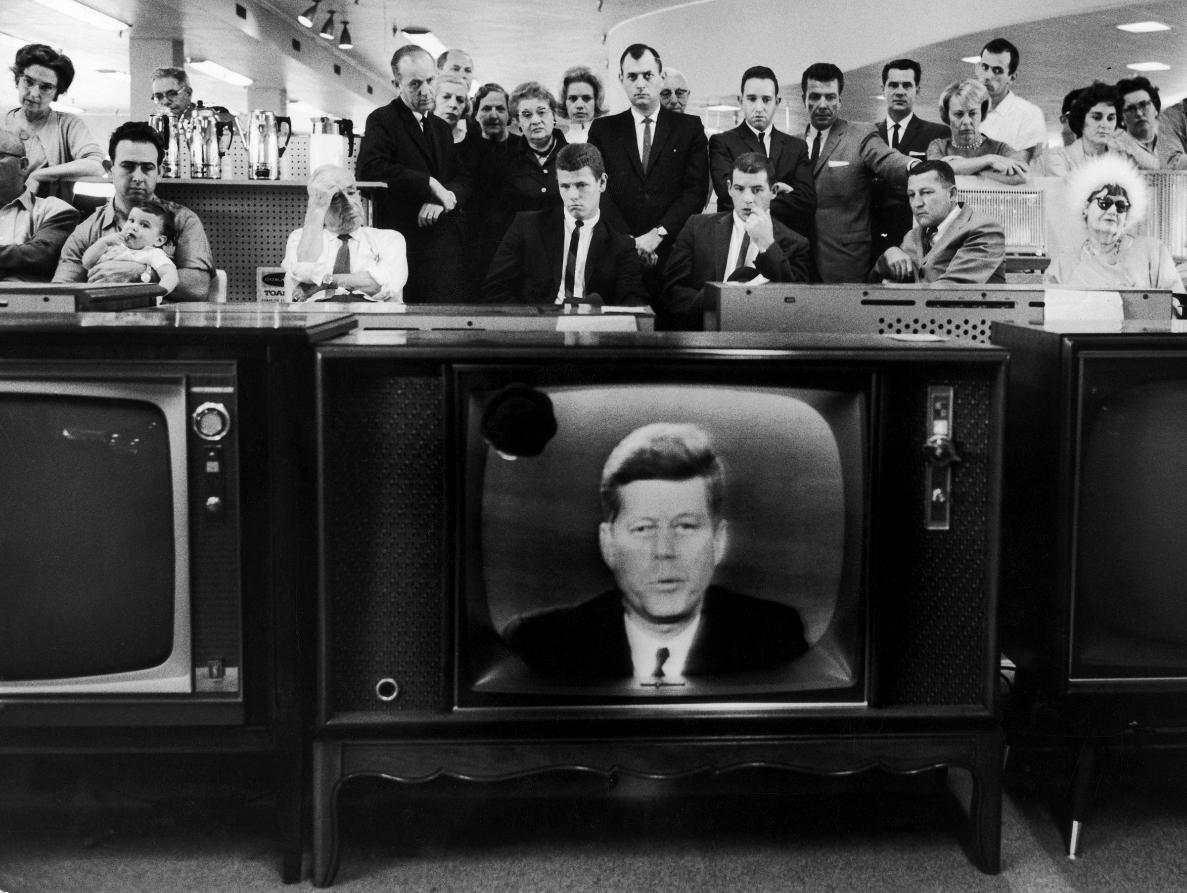 People watching President John F. Kennedy's TV announcement of Cuban blockade during the missile crisis in a department store in California on Oct.22, 1962.