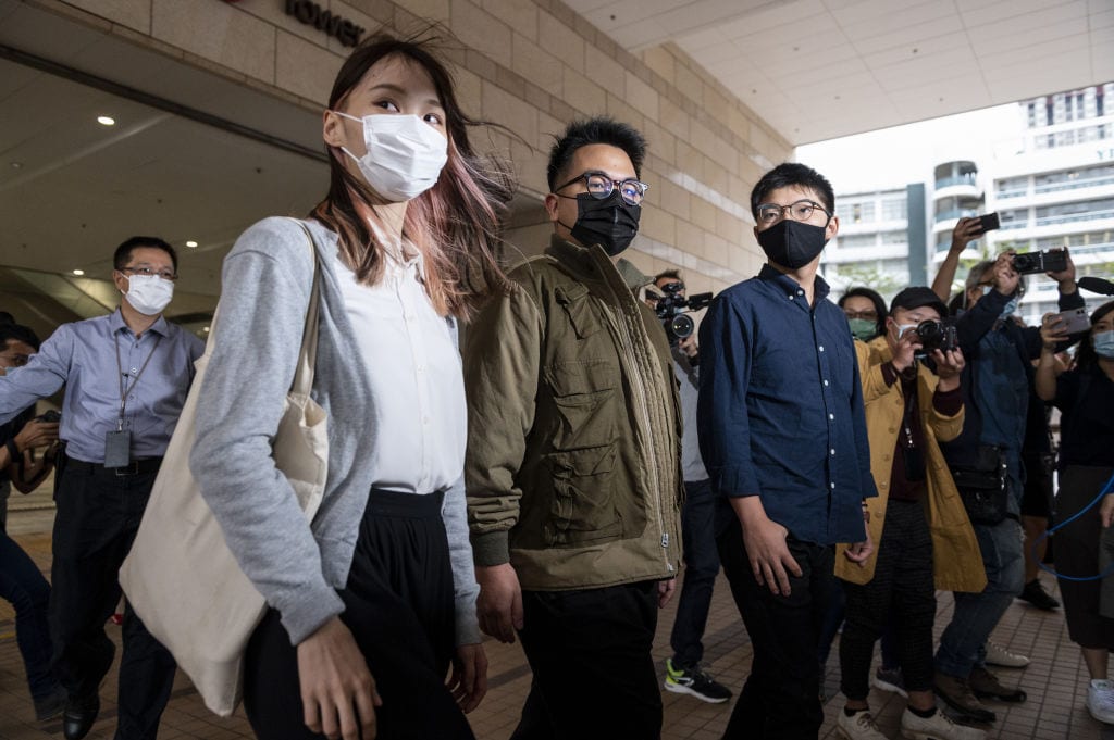 Agnes Chow (L), Ivan Lam (C), and Joshua Wong (R) arrive at the West Kowloon Law Courts building on Nov. 23, 2020 in Hong Kong.