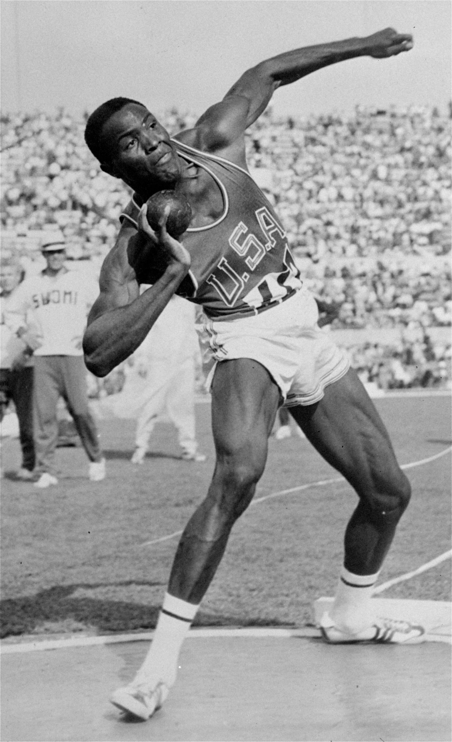 In this Sept. 5, 1960, file photo, Rafer Johnson of the United States competes in the shot put event of the Olympic decathlon competition in Rome, Italy.
