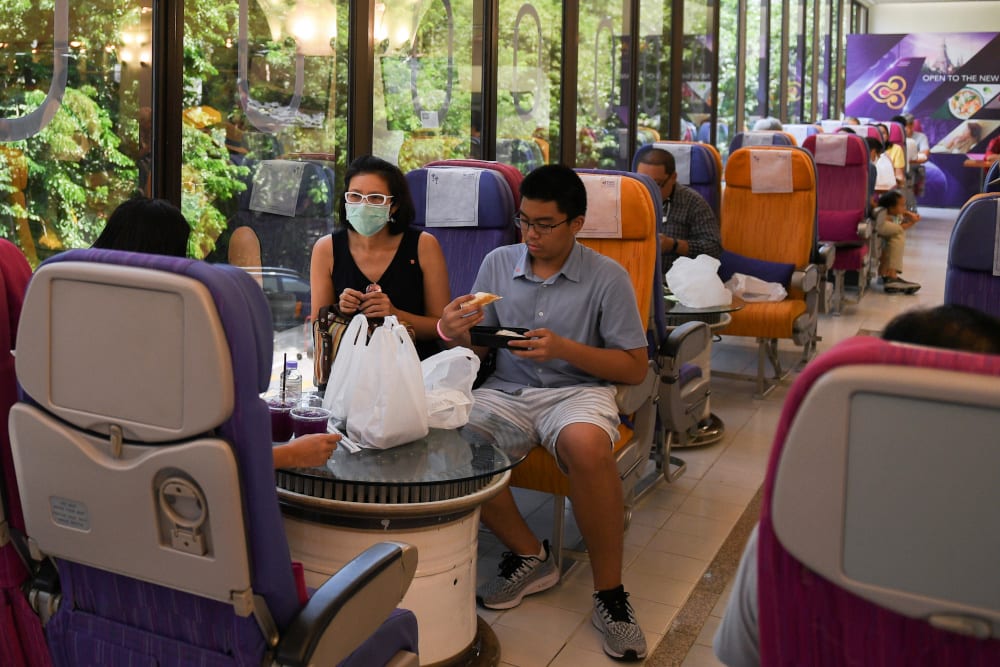 Customers eat at Thai Airways pop-up airplane-themed restaurant at the airlines headquarters with onboard meals prepared by their chefs, while their fleet is still grounded at the airport and the company awaits a bankruptcy court decision, in Bangkok, Thailand September 3, 2020. — Reuters pic